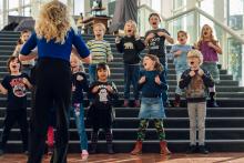 Children singing on the stairs of the foyer of Dutch National Opera & Ballet